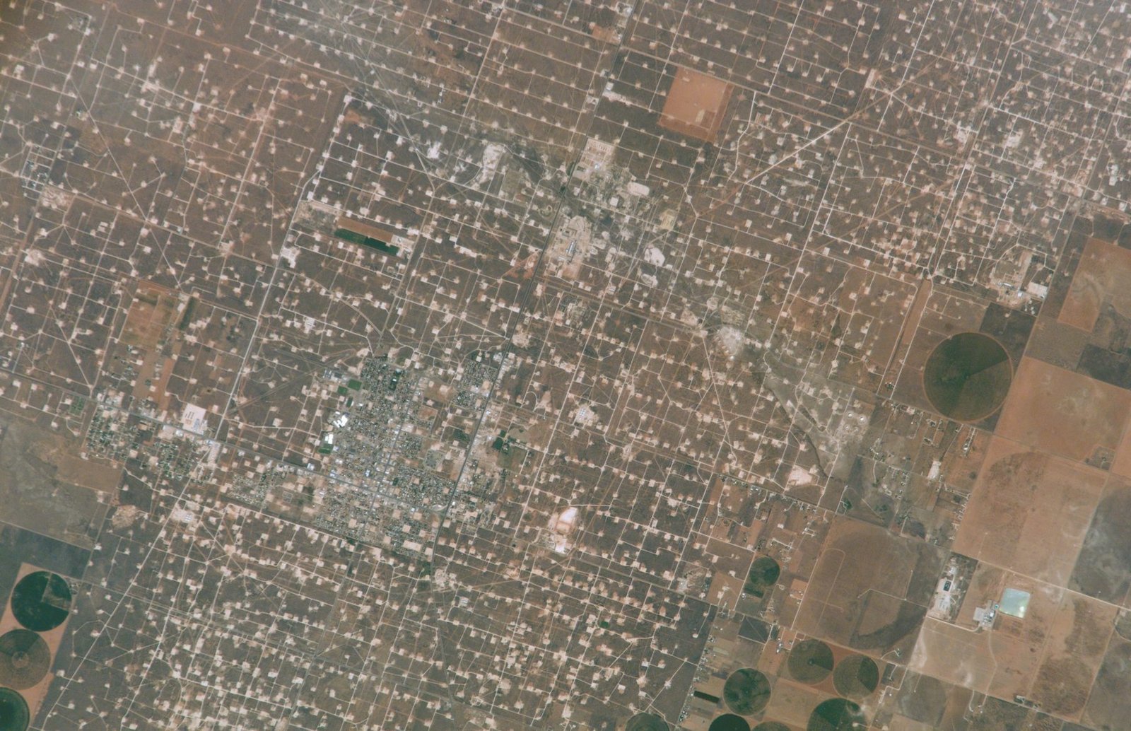 Satellite view of the Denver City street grid surrounded by well pads and fields